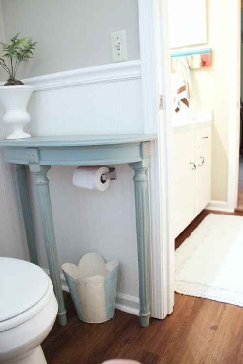 Add a half table over a toilet paper holder to save space in a small bathroom. | 33 Insanely Clever Upgrades To Make To Your Home