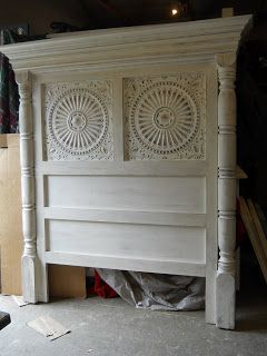 Custom headboard using porch posts and tin ceiling tiles. looks like a bit of crown molding as well. image only, no further