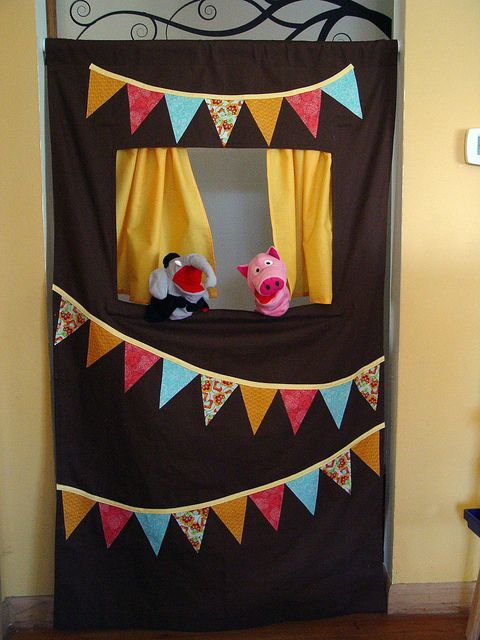Doorway puppet theater – held in place with a tension rod, easily rolled up for storage!  Kids LOVE it!
