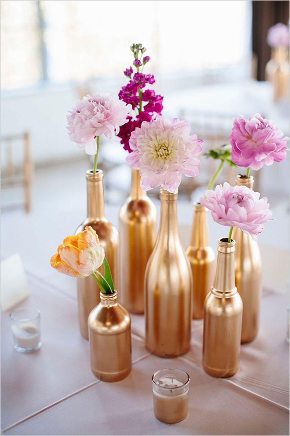 These spray-painted glass bottles look gorgeous as simple vases for individual blossoms.