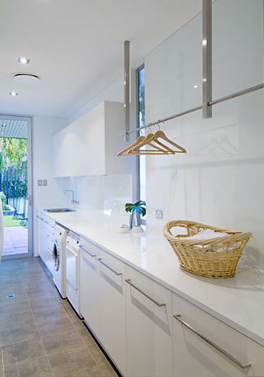glamorous white laundry room – great idea for hanging rails