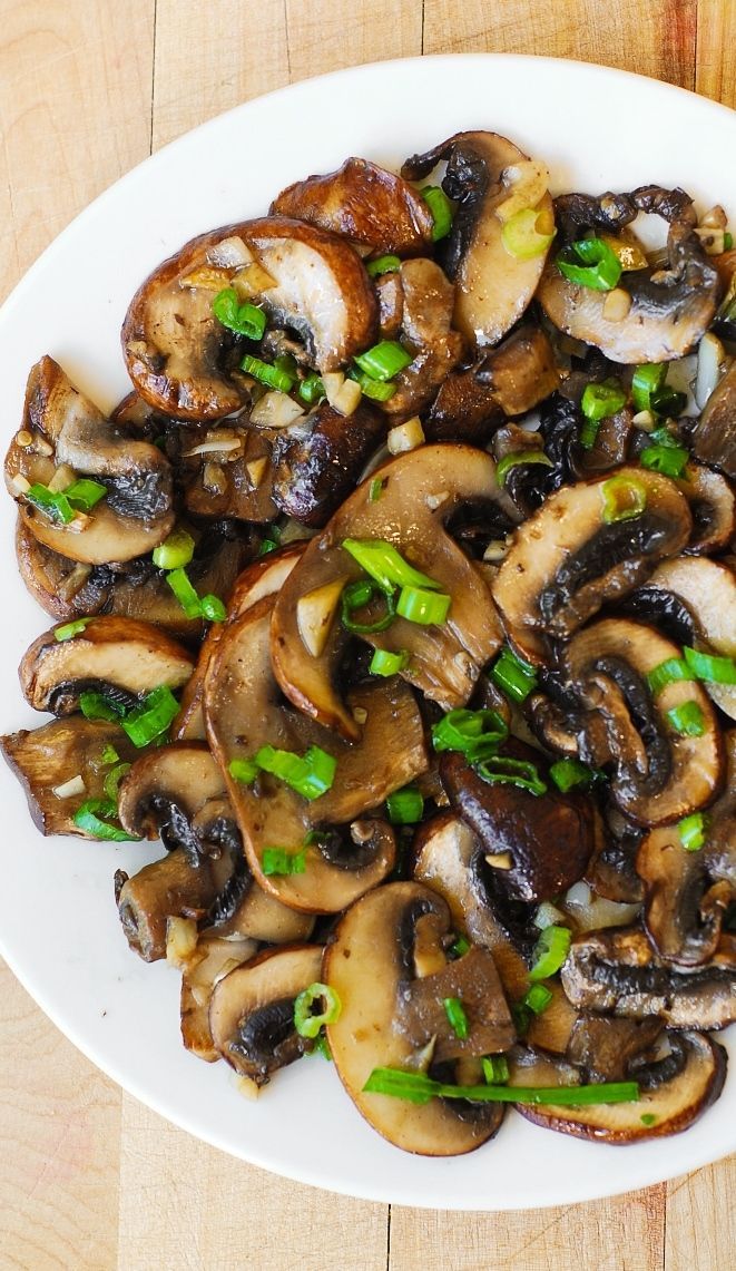 Mushrooms sauteed with garlic in olive oil and topped with green onions (or chives):