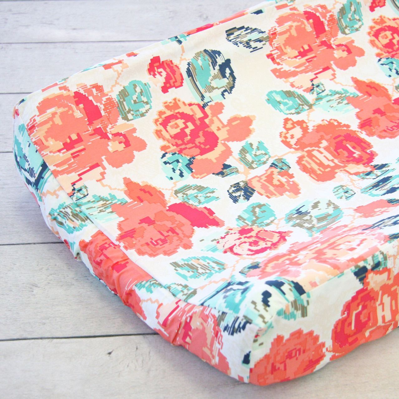 This floral changing pad cover from Caden Lane is the perfect color combination of coral and navy. This changing pad cover stand