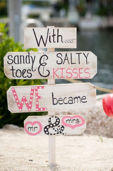 Beach wedding sign idea – “With sandy toes & salty kisses, we became Mr. & Mrs.” – colorful beach wedding