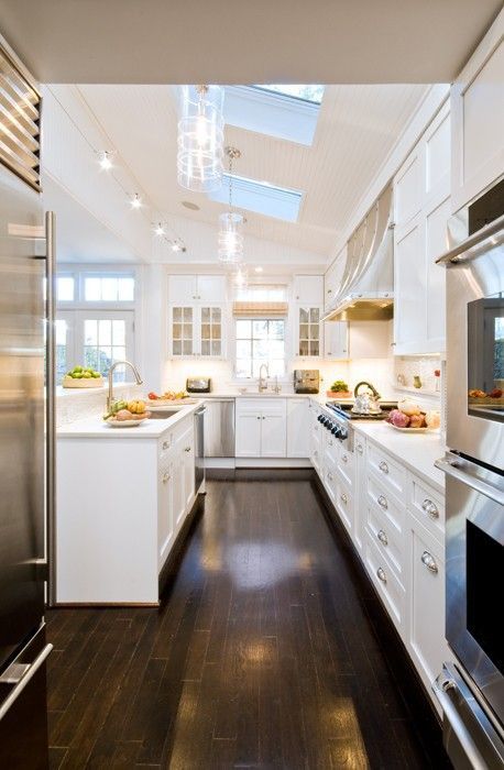 I’m a sucker for all-white kitchens.  Plus skylights and dark wood floors…