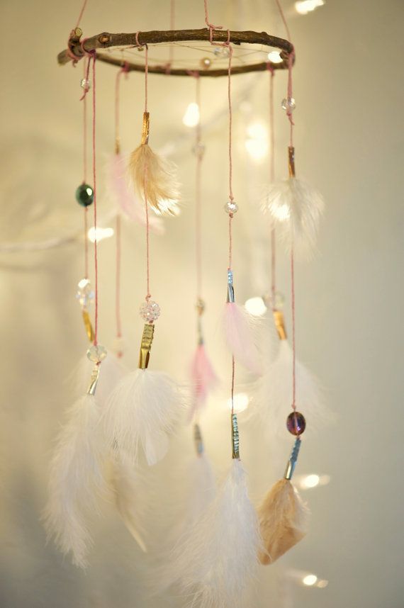 This is so soft and subtle, with its white, cream, and pink feathers. It features pink string and gold, si
