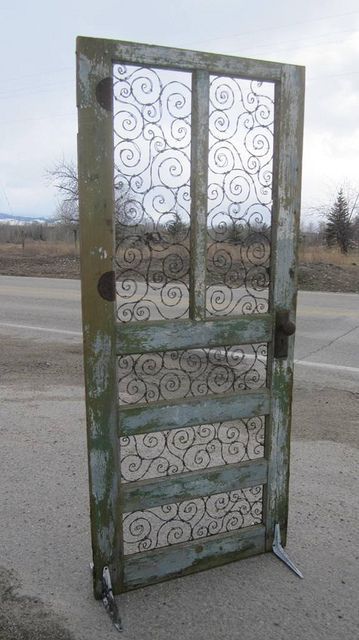Barbed wire spirals take the place of panels and glass. It stands with the help of old, shelving brackets.