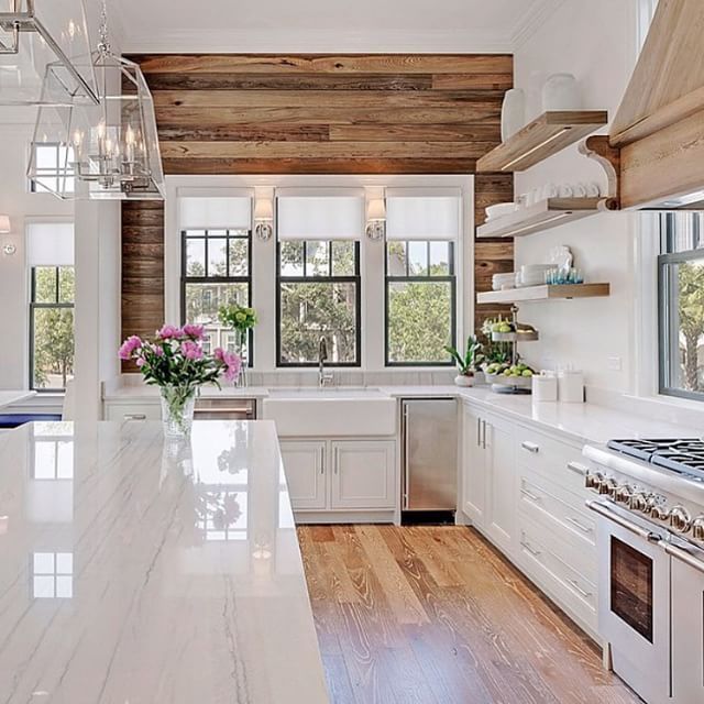 Beautiful wood paneling and floors to contrast with the white cabinets and countertops in the kitchen