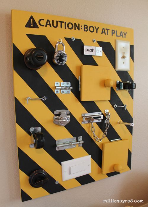 DIY busy board full of switches, latches, and doo-dads for babies and toddlers to manipulate.