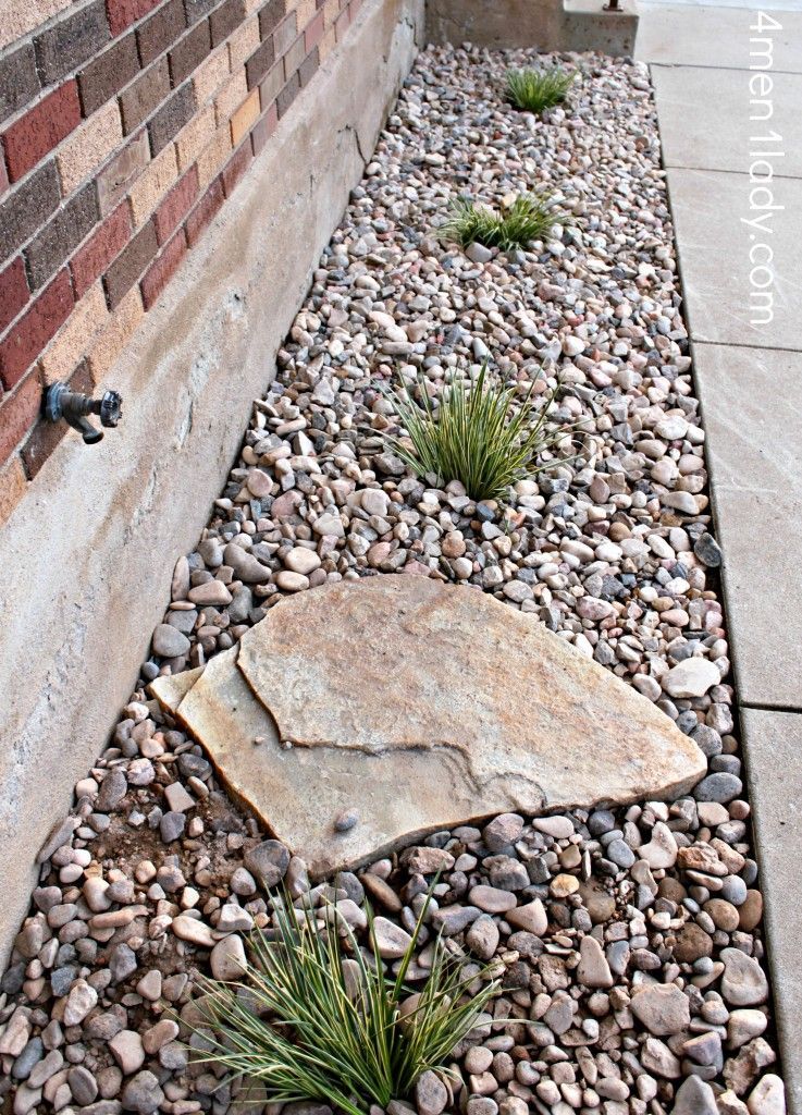 flower bed idea. Like the idea of the large rock to prevent erosion from the water spicket.