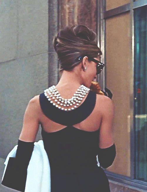 Holly Golightly in that iconic black Givenchy gown and pearl necklace.