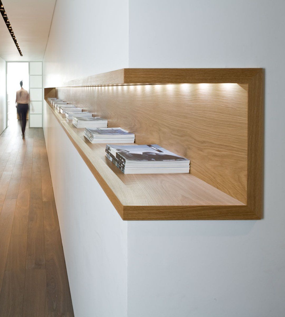 Interior architecture: wood shelf with in-built light. Neat and simple, love it!