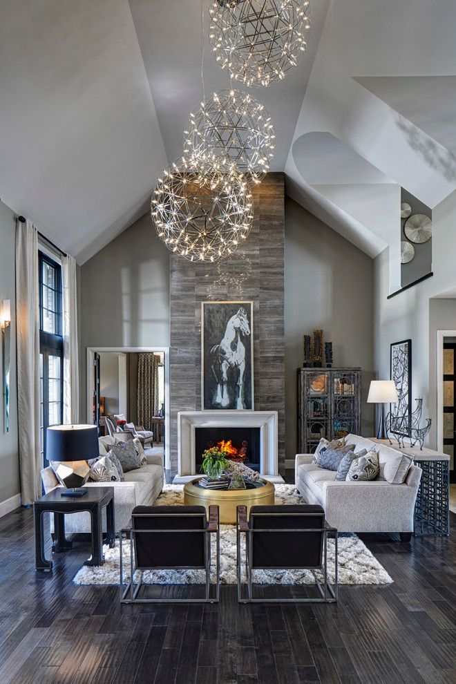 Living room, great room, dark rustic wood floors, stone fireplace, orb chandeliers, horse art | Moceri Hom