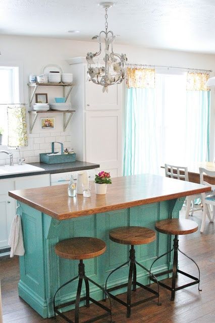 Make your island stand out with a pop of colour. Also love the iron stools.