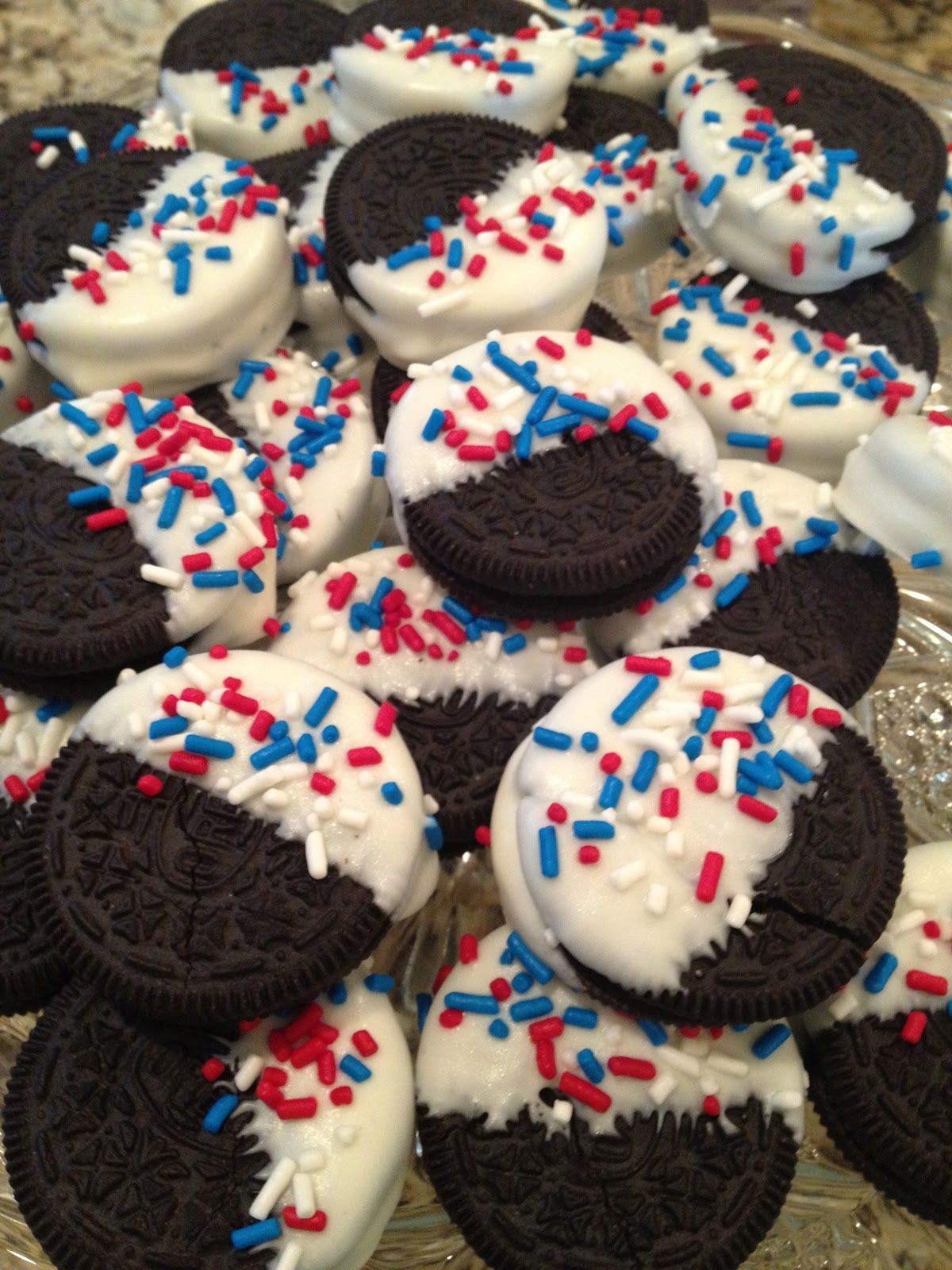 Patriotic Oreos covered in white sprinkled with red and blue. Sounds like a recipe for Memorial Day
