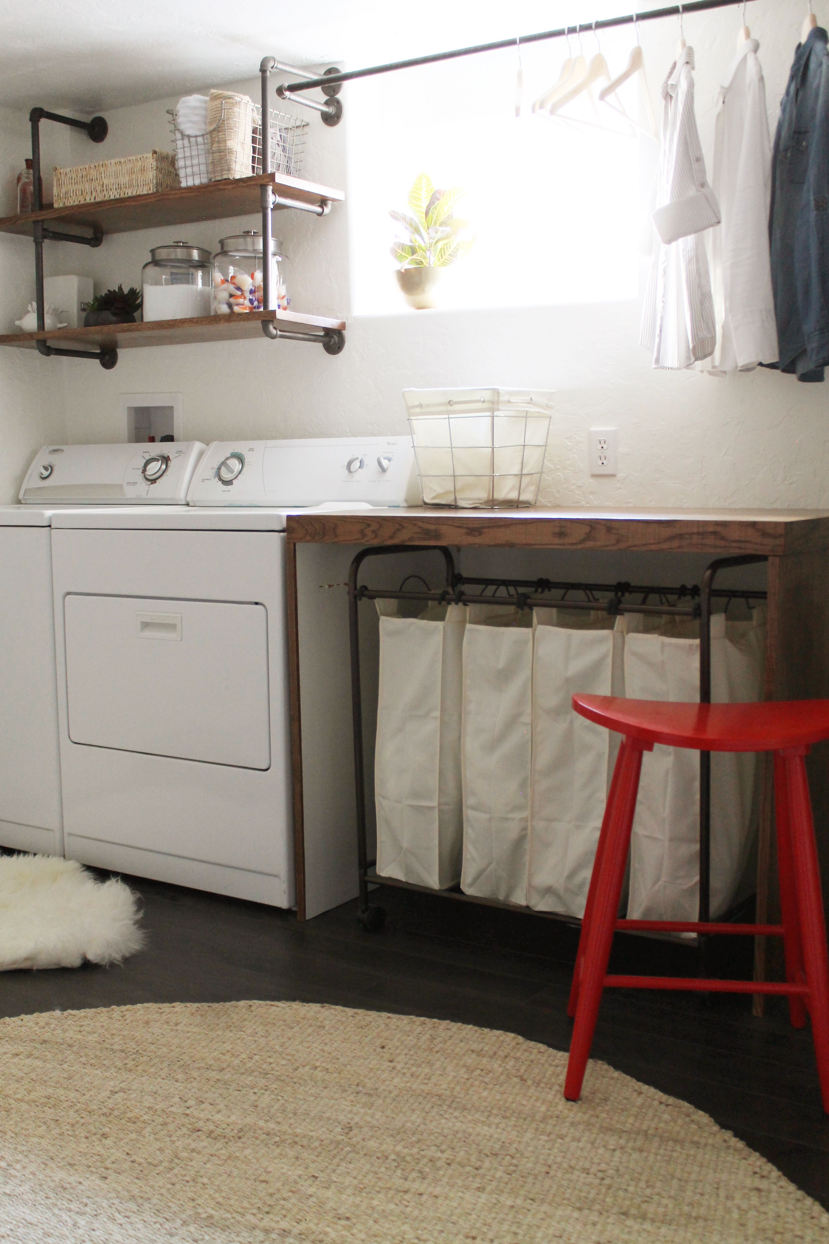 basement laundry room — I like the simplicity of this room, the wooden folding table, the shelves ove