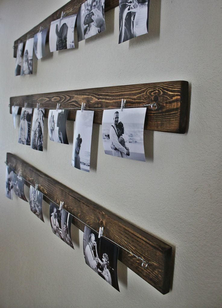 hipster way of displaying your family photo is done easily with wooden planks, clips and couple of wires.