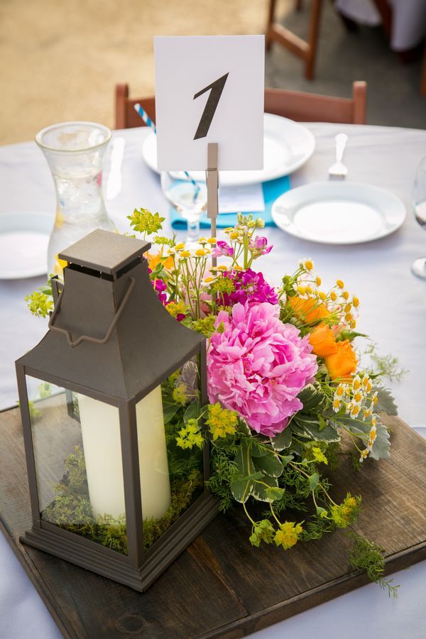 Lantern and floral centerpiece holds a graphic table number {Photo by A. Blake Photography via Project Wed