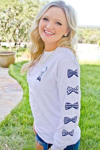 Showing off the blue bowed sleeve on our “Keeping it Classy since 1776” long-sleeve tee