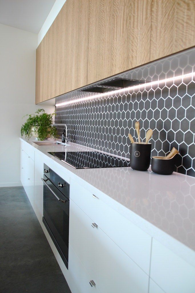 Split – Kitchen Detail White and timber, black hexagon feature tiles with recessed lighting Niche Design &