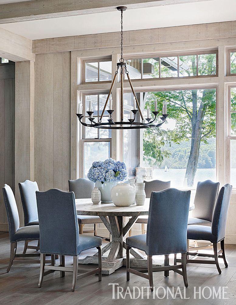 A “Lola” chandelier from Bungalow Classic hangs above the round elm dining table. Floors throughou