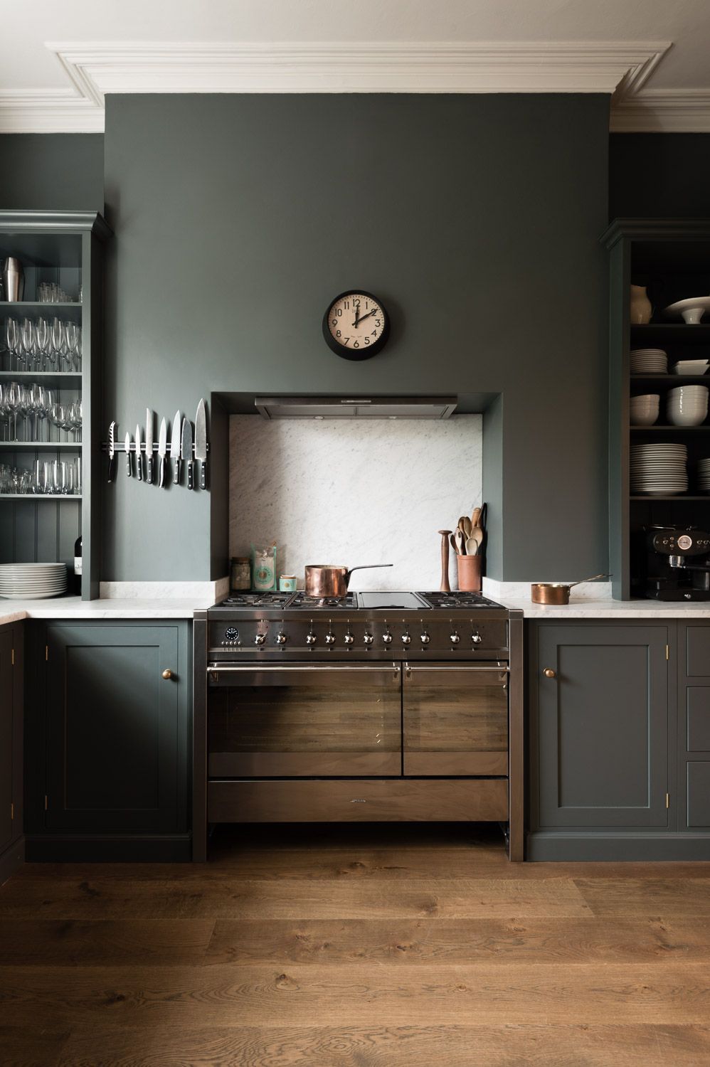 The cupboards, the colours, the honed marble worktop and the understated open cupboards either side of