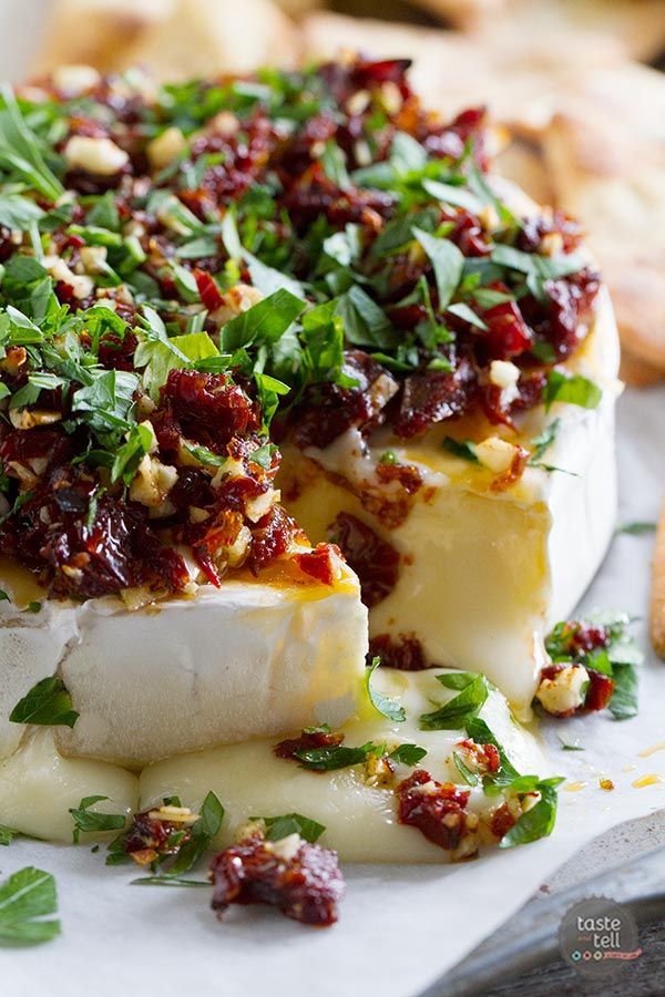 This baked brie recipe has melty cheese that is topped with a mixture of sun-dried tomatoes, garlic an