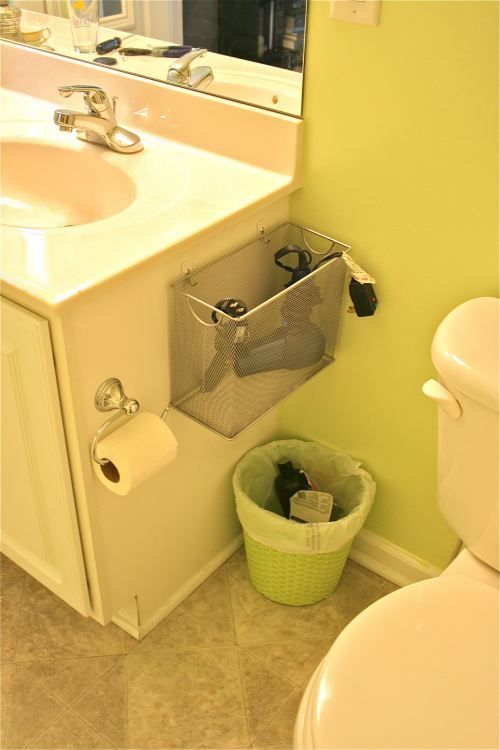 Use 3M hooks to hang a wire basket on the side of the bathroom counter. Easy and convenient storage fo