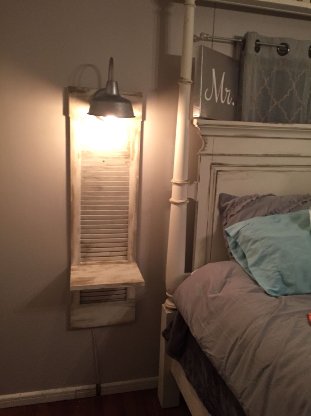 Old shutter turned into a nightstand. Great in a small space. This would also be good for a phone stat