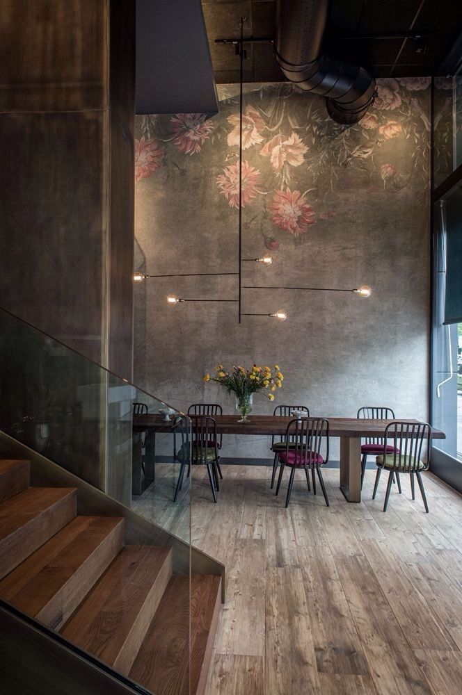 the high ceilings in concrete softened with a delicate pretty mural + unpolished wood flooring and sta