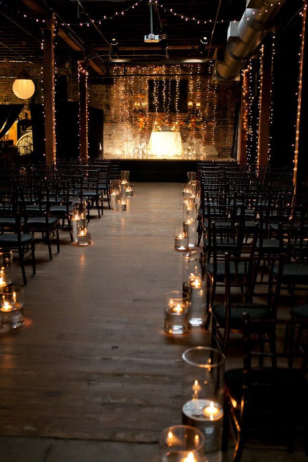 Impossibly romantic wedding ceremony set-up with twinkle lights and floating candl
