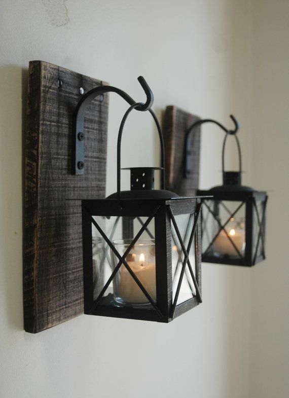 Lantern Pair with wrought iron hooks on recycled wood board for unique wall decor,