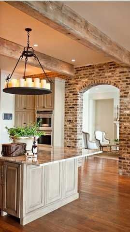 Beautiful kitchen with exposed brick and wood beams.