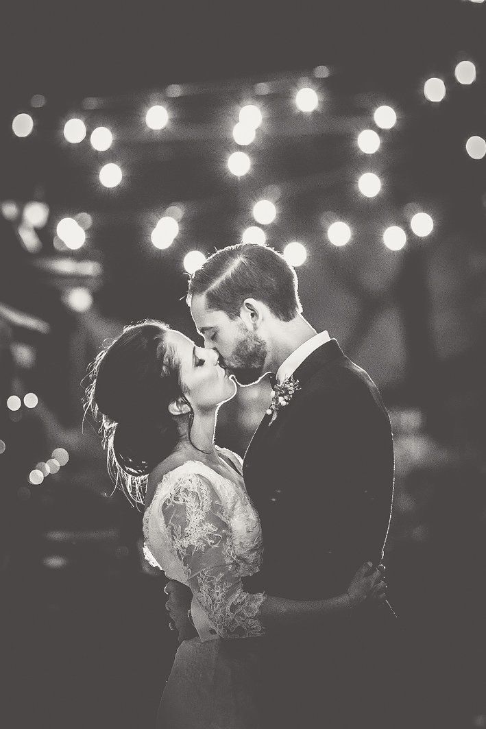 Bride and groom photo under festoon lights | Angela Rose Photography