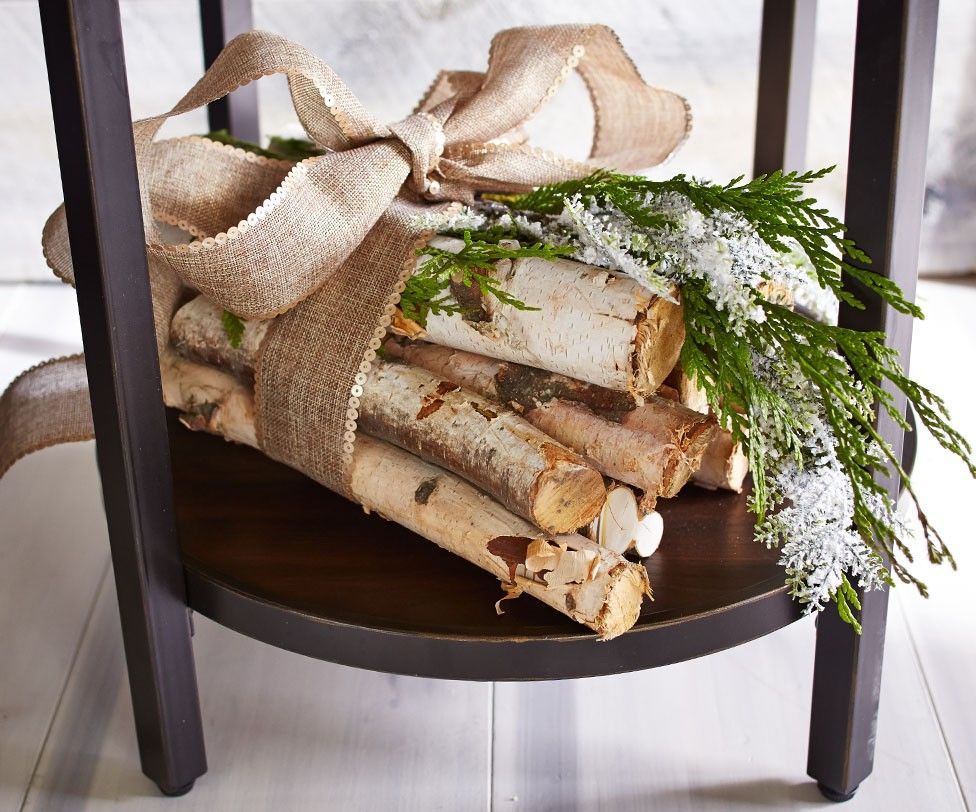 Bundle some logs and tie with a burlap ribbon for an easy Christmas display.