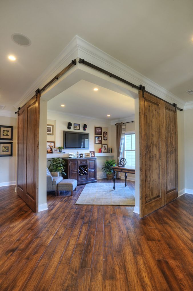 corner office or study area with double sliding barn doors, by Shumacher Homes