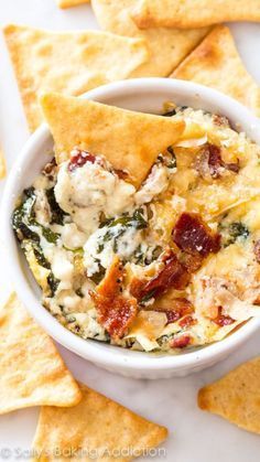 Creamy warm spinach dip made with roasted garlic, crispy bacon, and parmesan chees