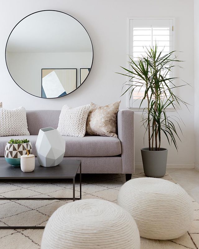 Neutral living room decor with clean lines and lots of texture // round mirror //