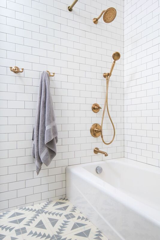 gold fixtures and patterned tile