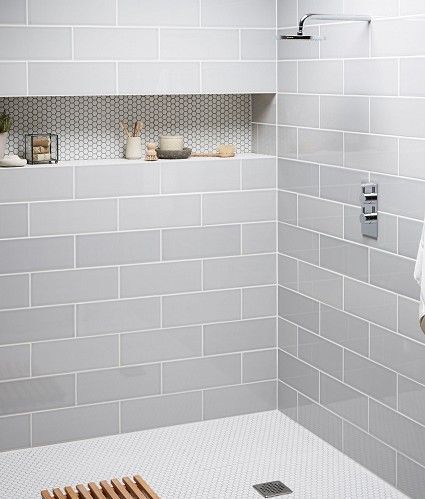 The muted colors of this shower alcove are fantastic. I love the contrasting grout color to make the penny tile pop.