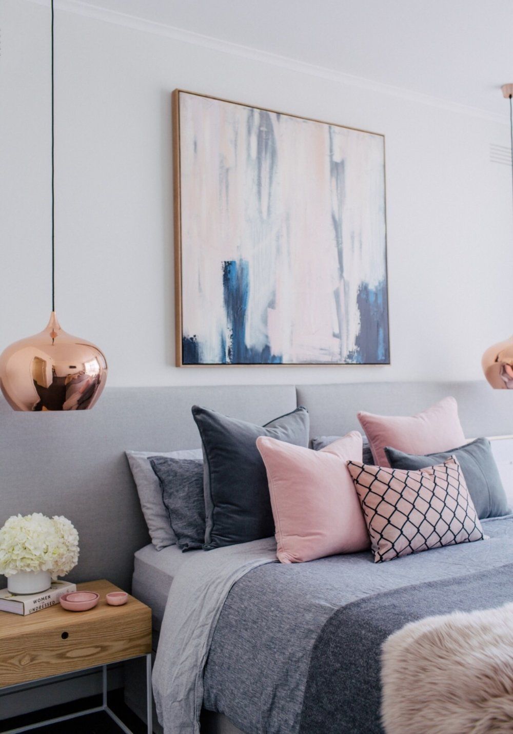 Bedroom inspiration for a great and pink Blush scheme with copper, textures and coloured cushion in grey, pink and pattern.