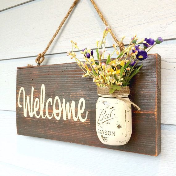 Hand painted Welcome real wood sign. Includes rope for hanging and the Mason jar (flowers not included). I can do any color combo