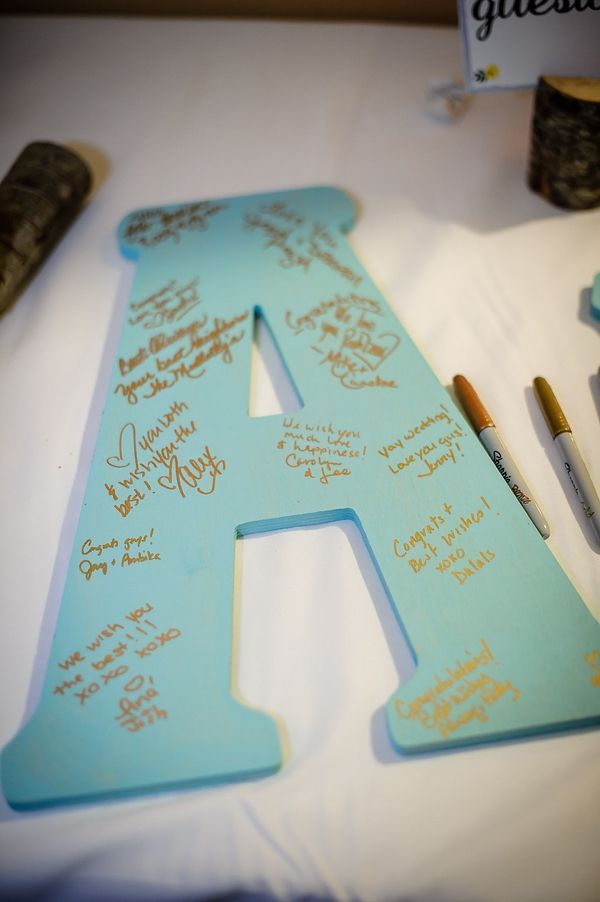 Have guests write their well wishes on large wooden initials. What a fun idea! /// Photo by Gray Photography via Project Wedding