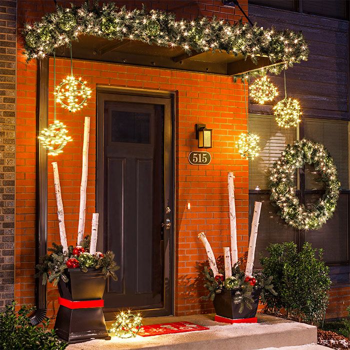 Brighten up an entry with Christmas string lights and lighted garland. -   Door Decoration Ideas