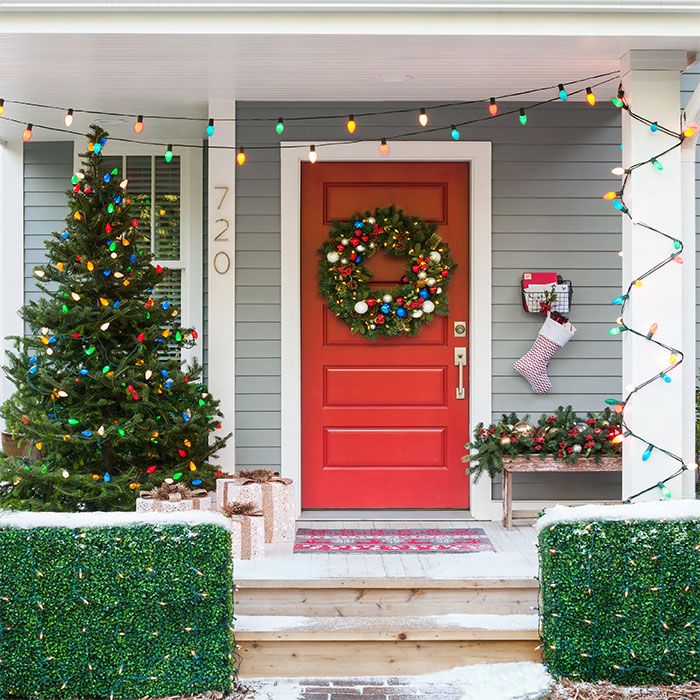 Red front door and porch decorated with Christmas wreath, outdoor ... -   Door Decoration Ideas