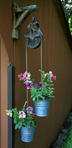 small pulley with buckets and flowers -Put it on the side of the garage next year