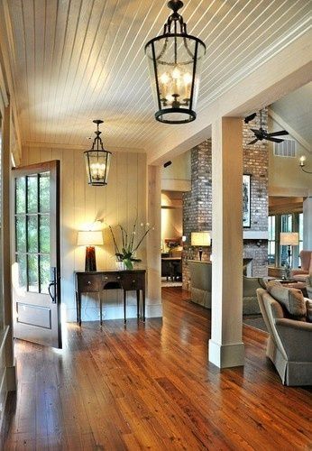 lanterns, planked walls and ceiling, entry door, fireplace, creams and wood by delia