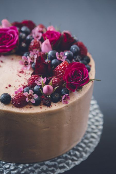 simple chocolate cake with berries and fresh flowers