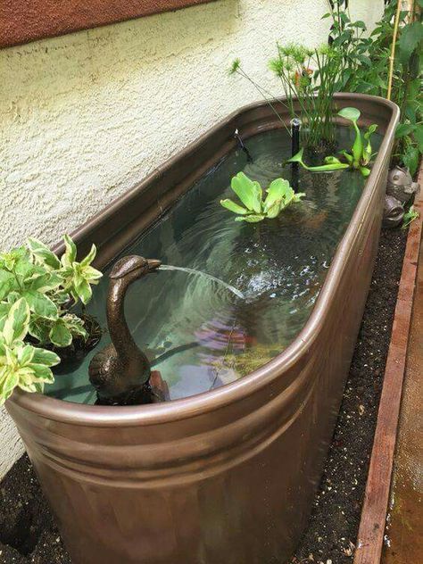 A stock tank is given a makeover with metallic copper color paint and transformed into a beautiful fountain!