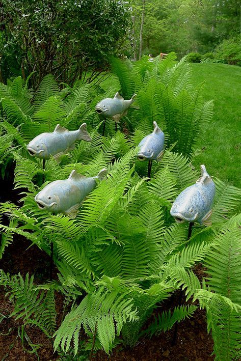 Fish garden sculptures – The ferns appear to be  aquatic plants with the fish swimming through.